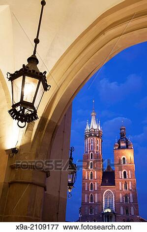 Cloth Hall and Lamp with Mariacka Basilica Church; Krakow; Poland, Illuminated at Night. View Large Photo Image Stock Photo - Cloth Hall and Lamp with Mariacka Basilica Church; Krakow; Poland, Illuminated at Night.. Fotosearch