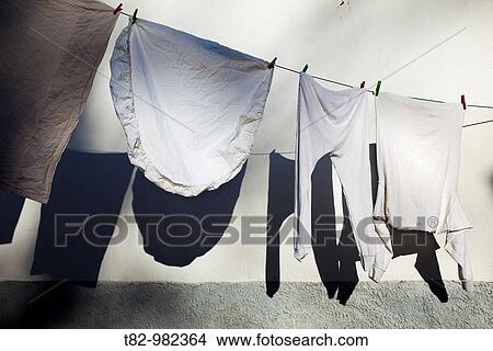 Clothes drying in the sun, shadow on the wall. Andalusia, Spain View Large Photo Image Picture - Clothes drying in the sun, shadow on the wall. Andalusia, Spain. Fotosearch