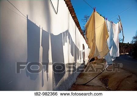 Clothes drying in the sun, shadow on the wall. Andalusia, Spain View Large Photo Image Stock Photograph - Clothes drying in the sun, shadow on the wall. Andalusia, Spain. Fotosearch