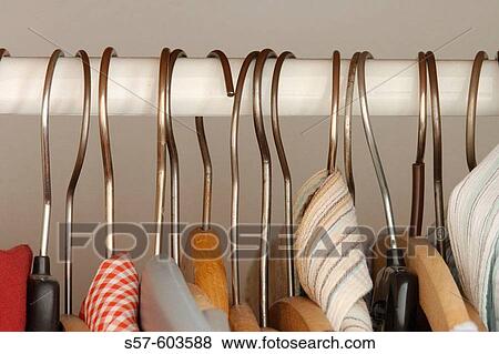 Clothes hangers on wardrobe rail View Large Photo Image Stock Photo - Clothes hangers on wardrobe rail. Fotosearch