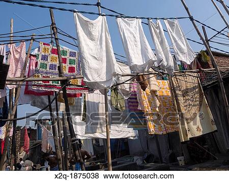 Stock Photo - Clothes hanging to dry at Dhobi Ghat an outdoor laundry facility in Mumbai India. Fotosearch