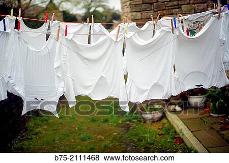 Clothes stretched in a court of a house. England, UK, Europe. View Large Photo Image Stock Photo - Clothes stretched in a court of a house. England, UK, Europe.. Fotosearch