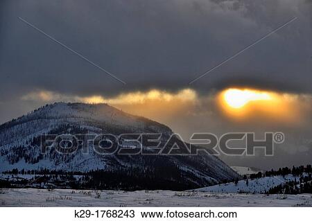 Cloud bank and setting sun over Bunsen Peak, Yellowstone NP, Wyoming, USA View Large Photo Image Stock Image - Cloud bank and setting sun over Bunsen Peak, Yellowstone NP, Wyoming, USA. Fotosearch