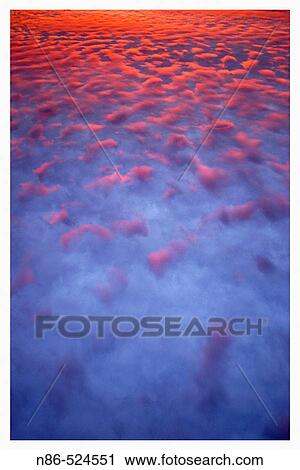 Stock Image - Clouds at sunset. Fotosearch