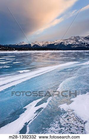 Clouds glowing in a winter sunset over the wind polished ice of Abraham Lake, Alberta Canada View Large Photo Image Stock Image - Clouds glowing in a winter sunset over the wind polished ice of Abraham Lake, Alberta Canada. Fotosearch