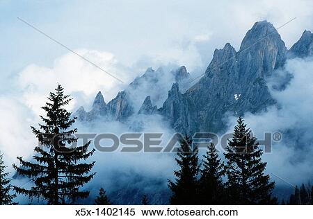 Clouds hugging the Swiss Alps, Switzerland View Large Photo Image Stock Photography - Clouds hugging the Swiss Alps, Switzerland. Fotosearch