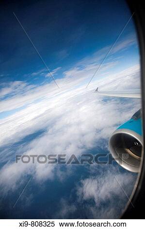 Clouds through an airplane window View Large Photo Image Stock Photography - Clouds through an airplane window. Fotosearch