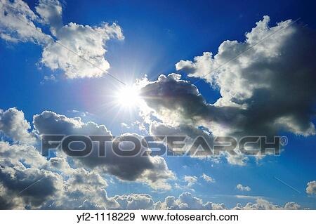 cloudy blue sky with bright shiny sun View Large Photo Image Stock Photo - cloudy blue sky with bright shiny sun. Fotosearch