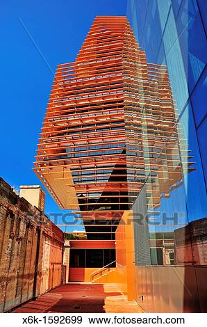Stock Photo - CMT (Comisi? n del Mercado de las Telecomunicaciones, Spanish communications industry regulator) building (Batlle i Roig Arquitectes). Agbar Tower reflection on glass facade. 22@ district, Barcelona, Catalonia, Spain.. Fotosearch