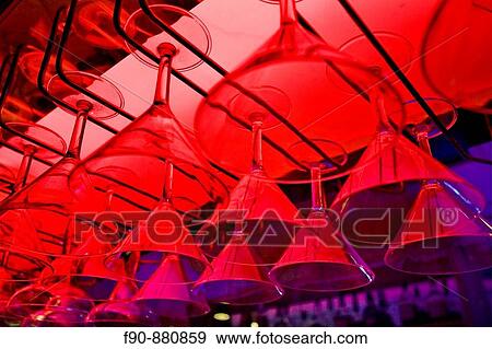 Cocktail glasses hang in bar View Large Photo Image Stock Photo - Cocktail glasses hang in bar. Fotosearch