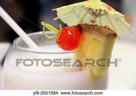 Cocktail with paper umbrella and fruit. View Large Photo Image Picture - Cocktail with paper umbrella and fruit.. Fotosearch