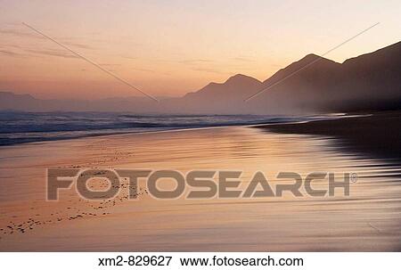 Stock Photo - Cofete beach at sunset, Fuerteventura, Canary islands, Spain. Fotosearch