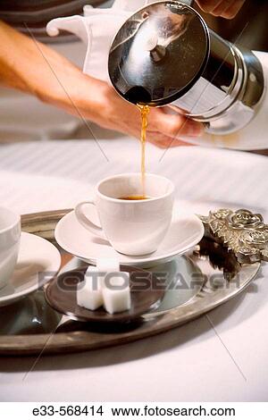 Picture - Coffee being poured into espresso cup.. Fotosearch