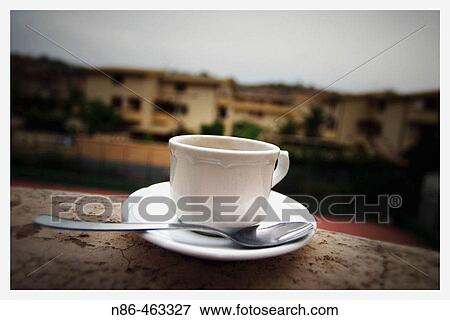 Coffee cup and saucer on ledge in Sicily. Italy View Large Photo Image Stock Photo - Coffee cup and saucer on ledge in Sicily. Italy. Fotosearch