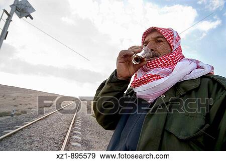 Coffee seller by railway crossing on the road to Palmyra, Syria View Large Photo Image Stock Photo - Coffee seller by railway crossing on the road to Palmyra, Syria. Fotosearch
