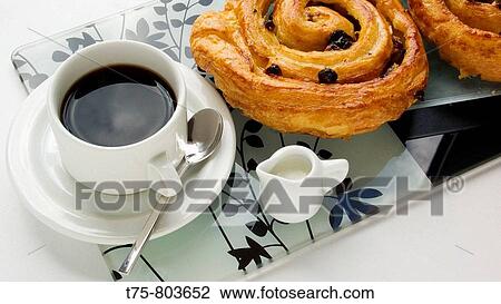 Stock Image - Coffee shells with butter and raisins.. Fotosearch