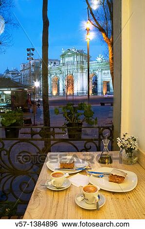 Coffee with cake for two at dusk. Independencia Square, Madrid, Spain. View Large Photo Image Stock Photograph - Coffee with cake for two at dusk. Independencia Square, Madrid, Spain.. Fotosearch