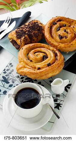 Coffee with pastries, shells with raisins and butter bread and chocolate pastry. View Large Photo Image Stock Image - Coffee with pastries, shells with raisins and butter bread and chocolate pastry.. Fotosearch