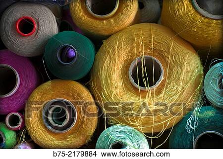 Picture - Coils of color threads for sewing and embroidery on a sewing workshop in the Medina of Fez, Morocco, Africa.. Fotosearch