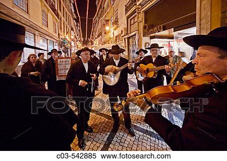 Stock Photography - Coimbra, Portugal: Wearing period costumes, folkloric society members sing on Dia De Reis (Day of the Kings, January 5) in honor of the Magi in the city's shopping district.. Fotosearch