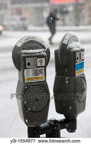 Coin operated parking meters in a snowstorm in White Plains, New York, USA View Large Photo Image Stock Photo - Coin operated parking meters in a snowstorm in White Plains, New York, USA. Fotosearch