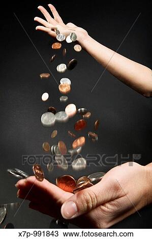 Coins dropping from one hand into another hand View Large Photo Image Stock Image - Coins dropping from one hand into another hand. Fotosearch