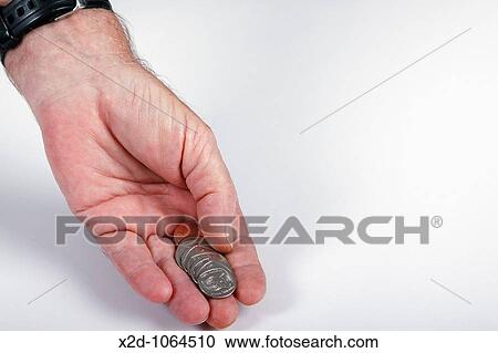 Stock Image - Coins in the palm of a man's hand Isolated Copy space. Fotosearch