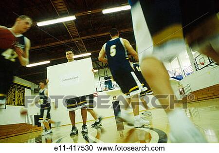 College basketball player holds? Commitment? sign. View Large Photo Image Stock Image - College basketball player holds? Commitment? sign.. Fotosearch