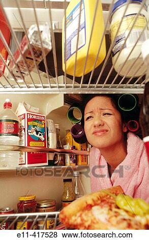 College girl in curlers looks in the refrigerator. View Large Photo Image Stock Photo - College girl in curlers looks in the refrigerator.. Fotosearch