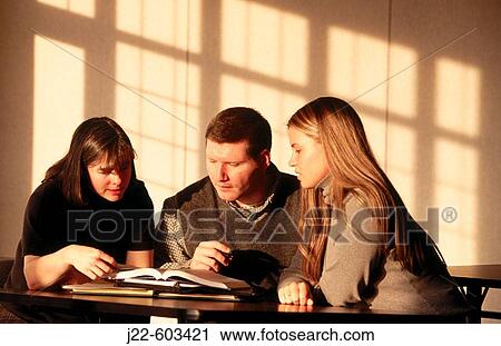 College professor and students talking over books View Large Photo Image Stock Image - College professor and students talking over books. Fotosearch