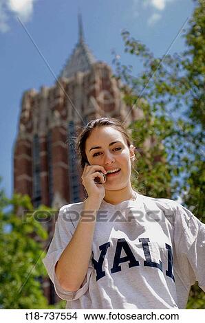 Picture - College student using cell phone. Fotosearch