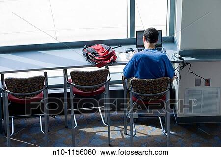 College student working on his laptop computer View Large Photo Image Stock Image - College student working on his laptop computer. Fotosearch