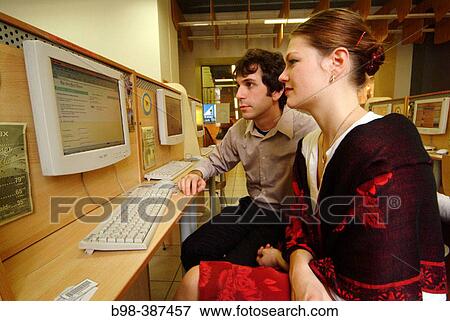 Stock Photo - College students use computer at internet cafe. St. Petersburg, Russia. Fotosearch