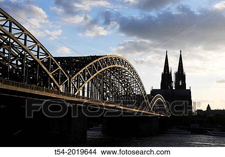 Cologne Cathedral and Hohenzollern Bridge at dusk View Large Photo Image Picture - Cologne Cathedral and Hohenzollern Bridge at dusk. Fotosearch