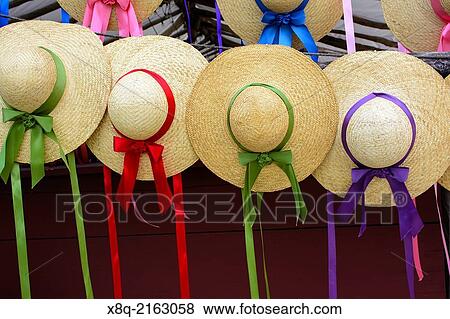 Stock Photo - Colonial style woven hats with ribbon, Williamsburg, Virginia.. Fotosearch