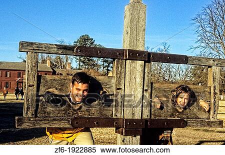 Colonial Williamsburg Virginia from the 1700s a tourist couple plays in stockade View Large Photo Image Stock Photography - Colonial Williamsburg Virginia from the 1700s a tourist couple plays in stockade. Fotosearch