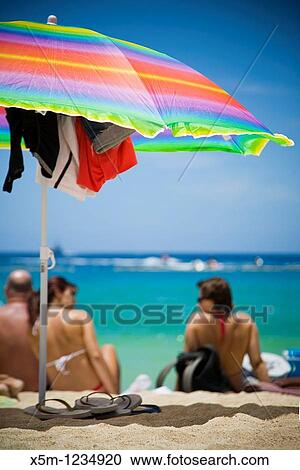 Colorful beach scene with parasol View Large Photo Image Stock Image - Colorful beach scene with parasol. Fotosearch