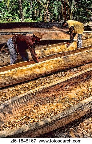 Colorful Builders building canal boats from trees in St Lucia Caribbean View Large Photo Image Stock Photo - Colorful Builders building canal boats from trees in St Lucia Caribbean. Fotosearch
