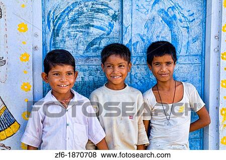 Colorful children aged 6 and 7 against blue wall portrait in Jaipur Rajasthan India View Large Photo Image Stock Photo - Colorful children aged 6 and 7 against blue wall portrait in Jaipur Rajasthan India. Fotosearch