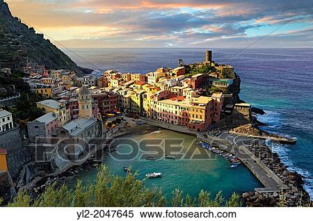 Colorful fishing houses, the fishing port of Vernazza at sunrise, Cinque Terre National Park, Ligurian Riviera, Italy. A UNESCO World Heritage Site. View Large Photo Image Stock Photography - Colorful fishing houses, the fishing port of Vernazza at sunrise, Cinque Terre National Park, Ligurian Riviera, Italy. A UNESCO World Heritage Site.. Fotosearch