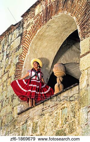 Colorful historical dancers in traditional dress in doorway from below in Oaxaca Mexico View Large Photo Image Stock Photo - Colorful historical dancers in traditional dress in doorway from below in Oaxaca Mexico. Fotosearch