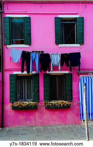 Stock Photo - Colorful house with hanging laundry in the island of Burano near Venice, Italy, Europe. Fotosearch