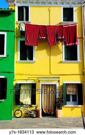 Colorful houses with hanging laundry in the island of Burano near Venice, Italy, Europe View Large Photo Image Stock Image - Colorful houses with hanging laundry in the island of Burano near Venice, Italy, Europe. Fotosearch