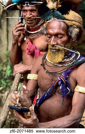 Colorful Huli Wigmen of Papua New Guinea with Palm Pilot and Cell Phone. View Large Photo Image Stock Photography - Colorful Huli Wigmen of Papua New Guinea with Palm Pilot and Cell Phone.. Fotosearch