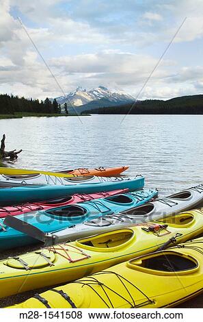 Colorful kayaks on Maligne Lake, Jasper National Park Alberta Canada View Large Photo Image Stock Photo - Colorful kayaks on Maligne Lake, Jasper National Park Alberta Canada. Fotosearch
