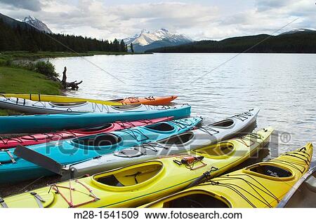 Stock Photo - Colorful kayaks on Maligne Lake, Jasper National Park Alberta Canada. Fotosearch
