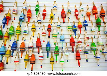 Colorful lobster trap bouy's hang from a wall in a harbor. Maine, USA View Large Photo Image Stock Image - Colorful lobster trap bouy's hang from a wall in a harbor. Maine, USA. Fotosearch