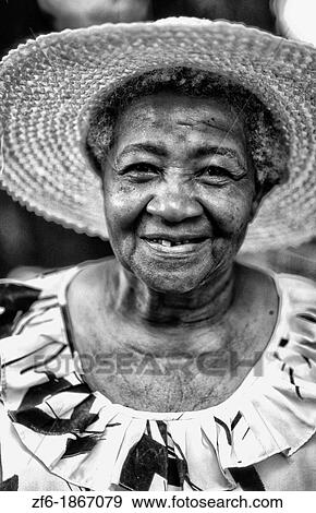 Colorful local woman in hat smiling portrait in the beautiful village of La Digue in the Seychelles Islands off of Africa View Large Photo Image Stock Photo - Colorful local woman in hat smiling portrait in the beautiful village of La Digue in the Seychelles Islands off of Africa. Fotosearch