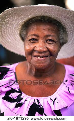 Colorful local woman in hat smiling portrait in the beautiful village of La Digue in the Seychelles Islands off of Africa View Large Photo Image Stock Photography - Colorful local woman in hat smiling portrait in the beautiful village of La Digue in the Seychelles Islands off of Africa. Fotosearch
