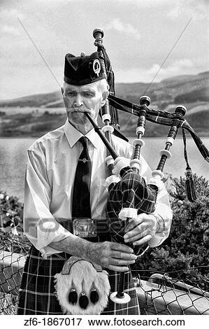 Colorful outfit and personality of bag pipe player at the Loch Ness area near Drumnadrochit home of the Loch Ness Monster Nessie in the Scotish Highland View Large Photo Image Stock Photo - Colorful outfit and personality of bag pipe player at the Loch Ness area near Drumnadrochit home of the Loch Ness Monster Nessie in the Scotish Highland. Fotosearch